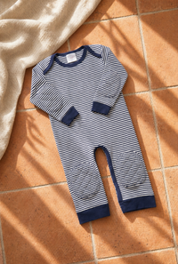 Navy Stripe padded onesie on warm terracotta tile with cream linen throw - Mediterranean morning light
